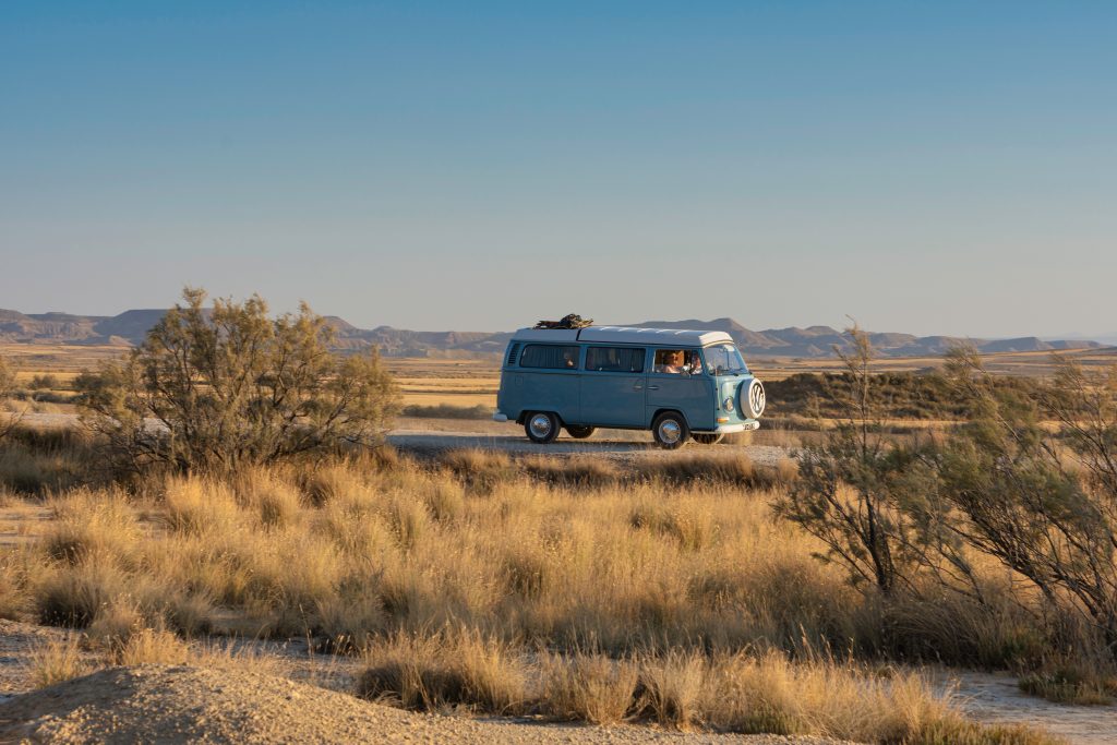 A vintage camper van parked in a scenic location