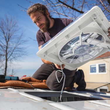 Man installing a van roof fan