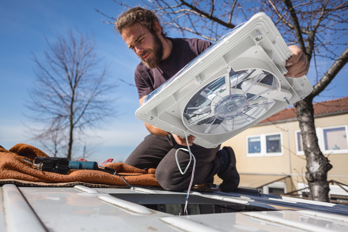 Man installing a van roof fan