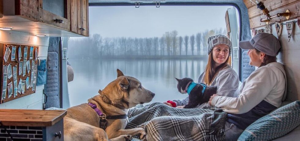 Em, Lou, Summer, and AJ enjoying a gorgeous lake view out of the back of their van