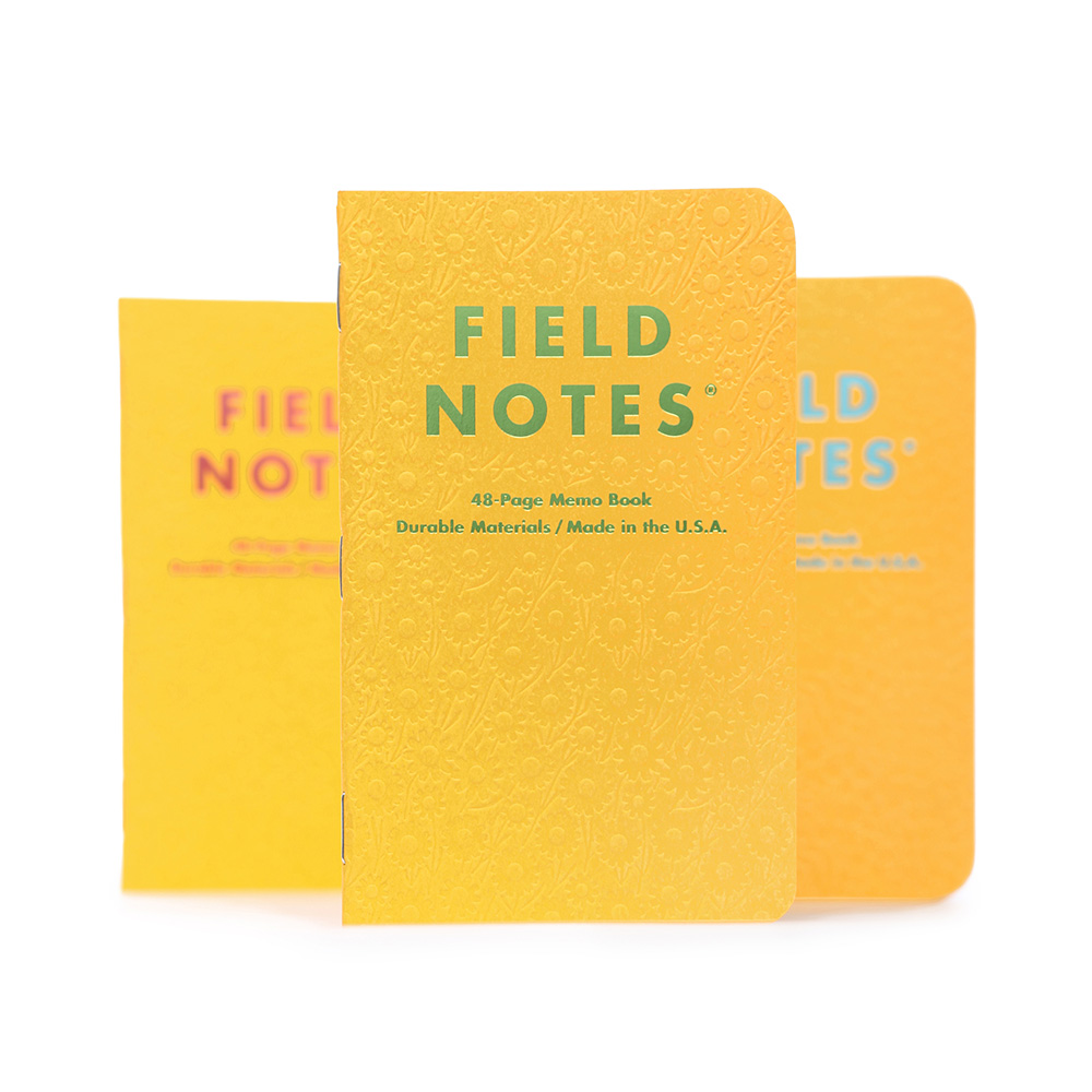 Field Notes Travel Journals with a yellow textured cover.