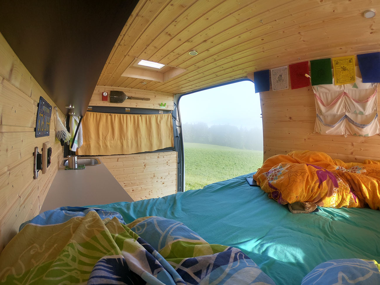 Interior of a van with a skylight and the door open