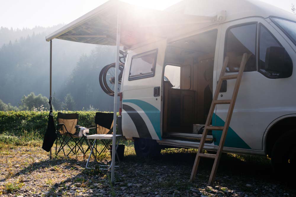 A camper van parked and set up to camp
