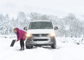 Shoveling snow near a van
