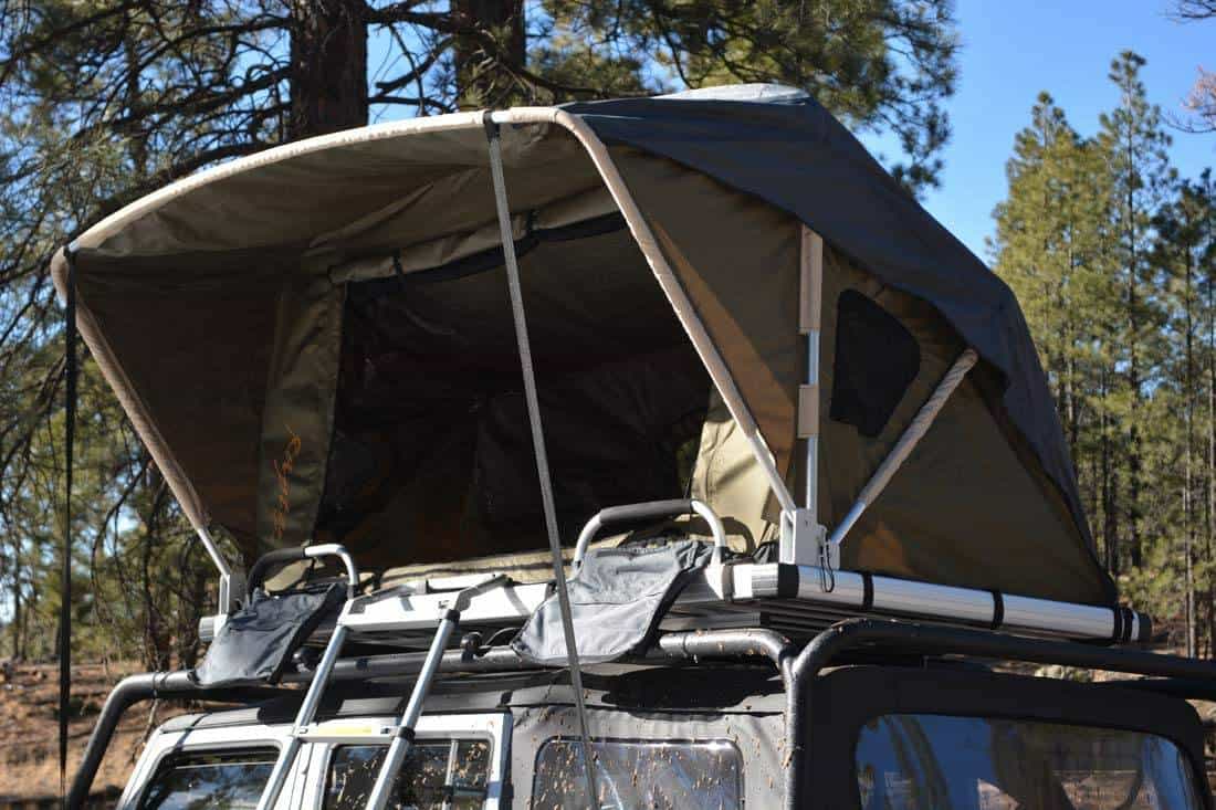 Two-person roof-top tent from Raptor set up atop a Jeep
