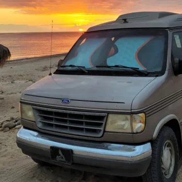 Van parked on the beach in Mexico.
