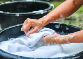 female hands washing clothes in basin
