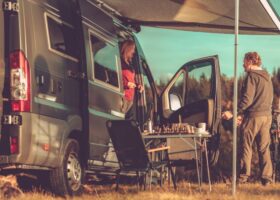 Couple with Class B RV Boondocking in Remote Place During Scenic Fall Foliage.