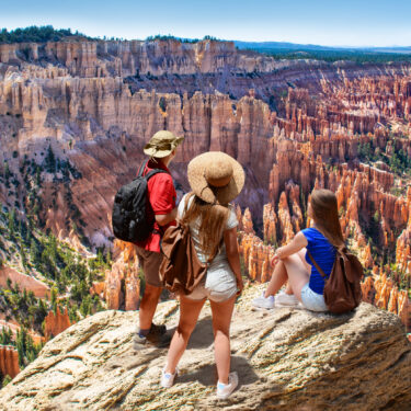 People on hiking trip looking at beautiful view of Bryce Canyon National Park, Utah, atop Inspiration Point