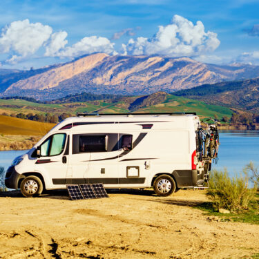 A van boondocking by a lake.