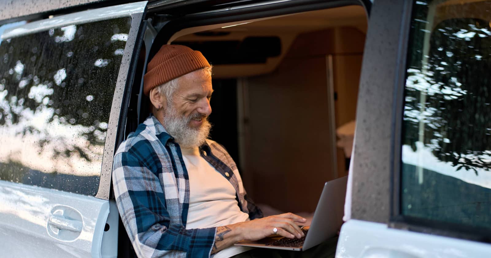 A man using the internet in his van.