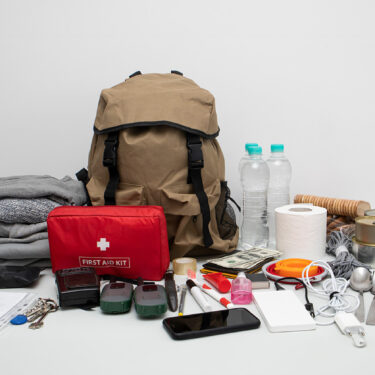 A survival kit with all of it's contents on a table.